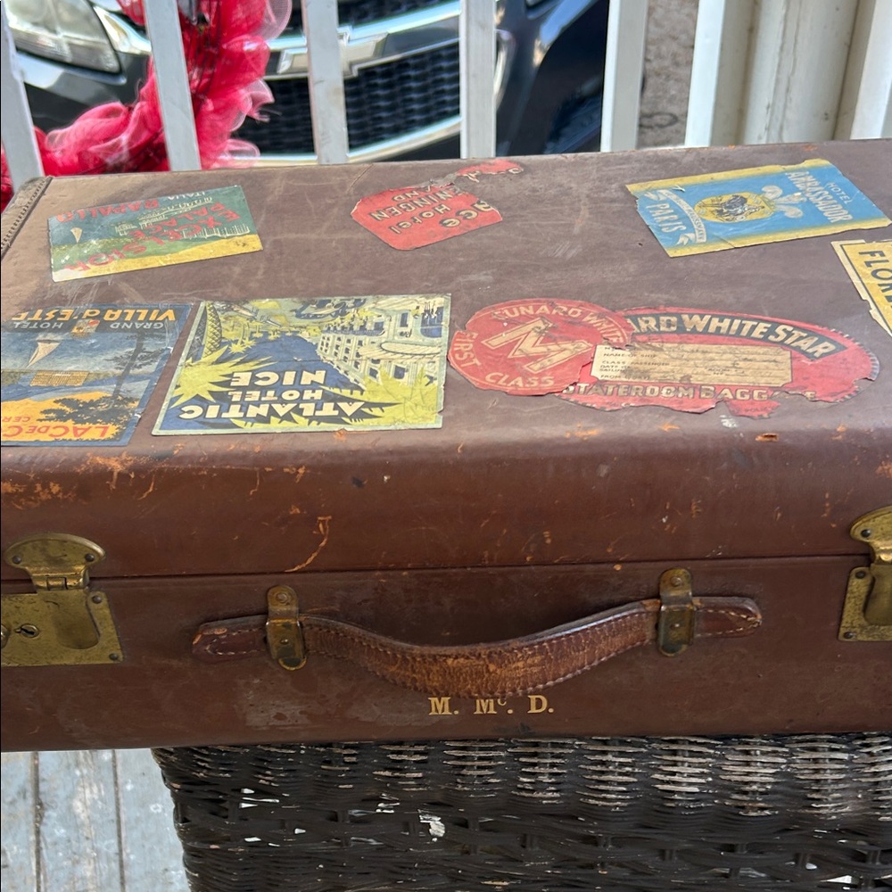 Vintage top grain suitcase with international travel stickers